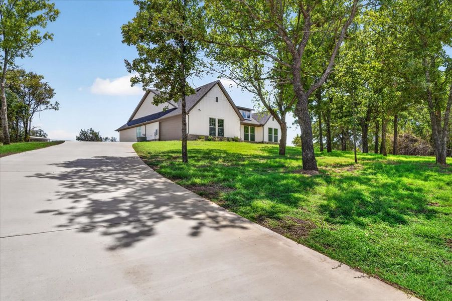 Front exterior of a new home in Monarch Manor, Poolville, TX, highlighting curb appeal (Image 30).