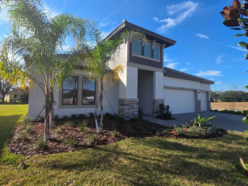 Front exterior of a new home in River Preserve Estates, Parrish, FL, highlighting curb appeal (Image 22).