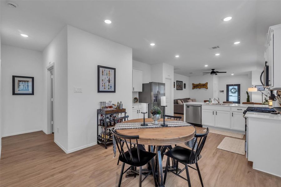The neutral flooring continues throughout the main areas of the house and the bathrooms. In the bedrooms is cozy carpet. To the right of the open door is the laundry room.