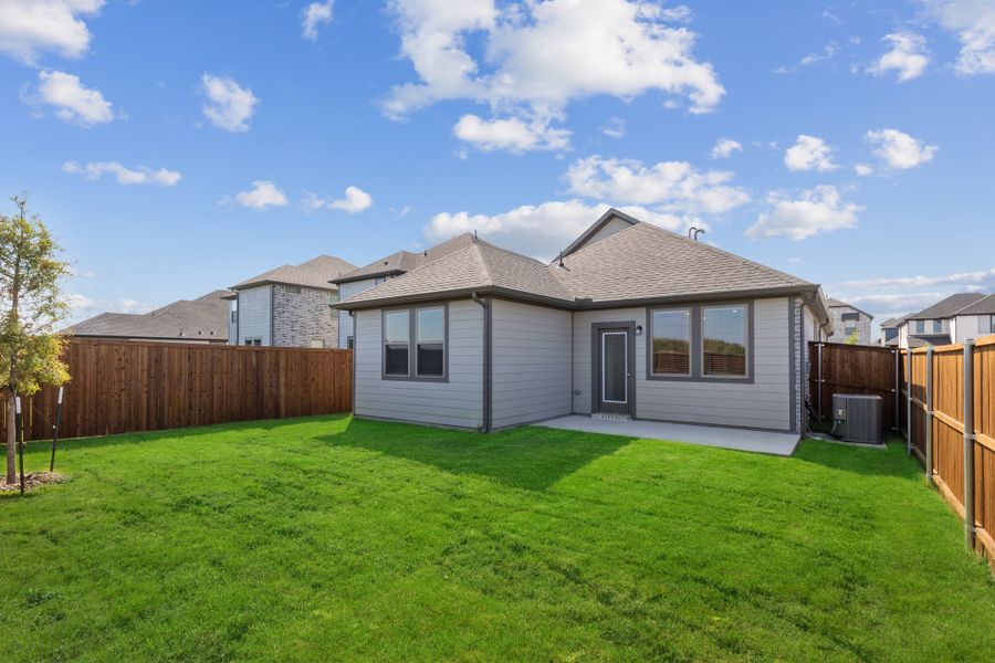 Backyard in the Elm home plan by Trophy Signature Homes – REPRESENTATIVE PHOTO