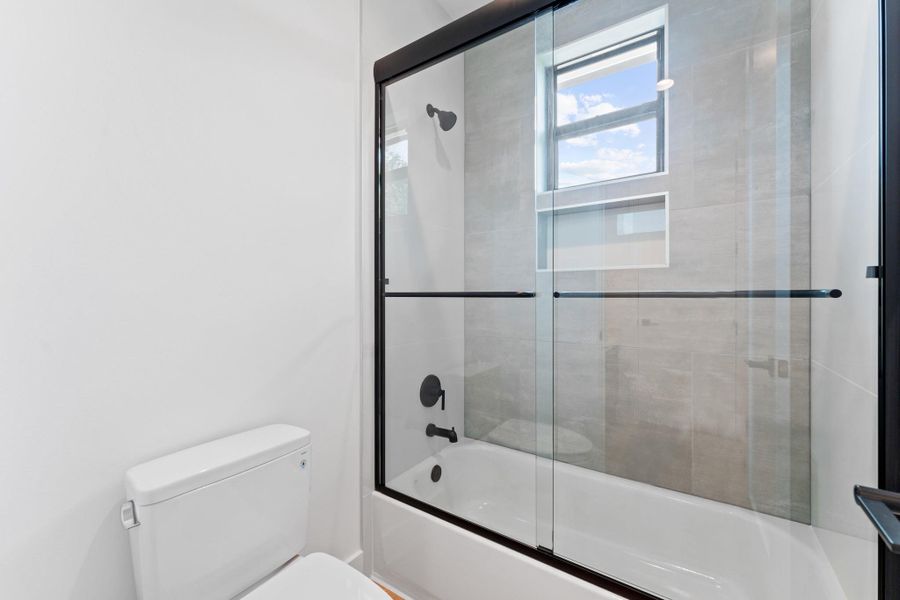Thoughtful tilework and clean fixtures make this upstairs bath feel elevated yet easy.