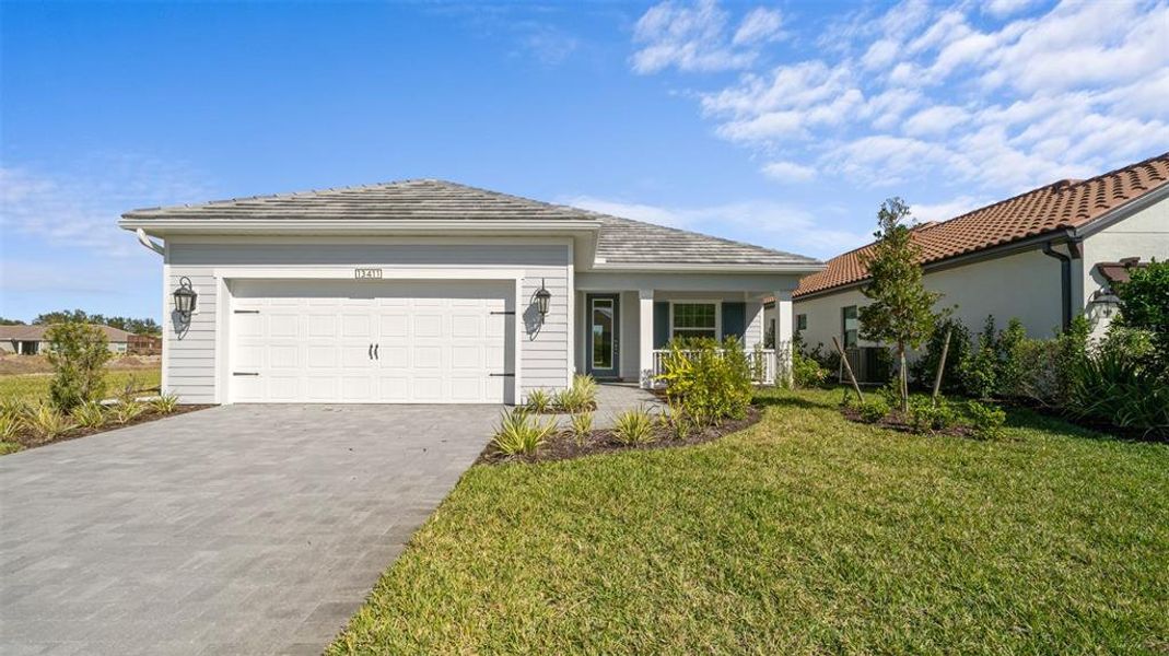 Front exterior of a new home in Verandah, Fort Myers, FL, highlighting curb appeal (Image 1). Front exterior of a new home in Verandah, Fort Myers, FL, highlighting curb appeal (Image 1).