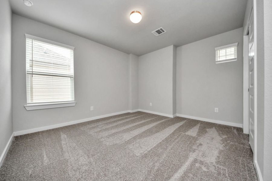 Secondary bedroom features plush carpeting, large windows that let in plenty of natural light, bright paint, and spacious closets. Secondary bedroom features plush carpeting, large windows that let in plenty of natural light, bright paint, and spacious closets.