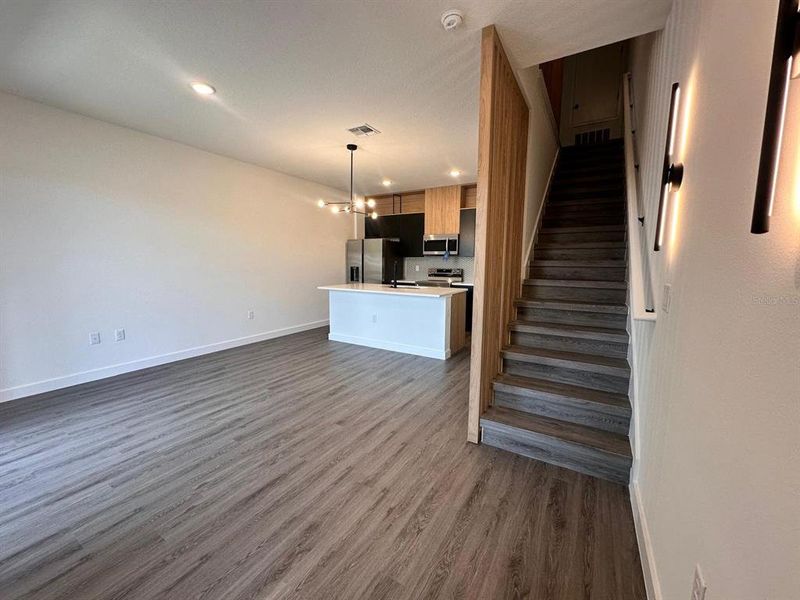 Upgraded cabinetry and lighting, quartz countertops, and wooden slats