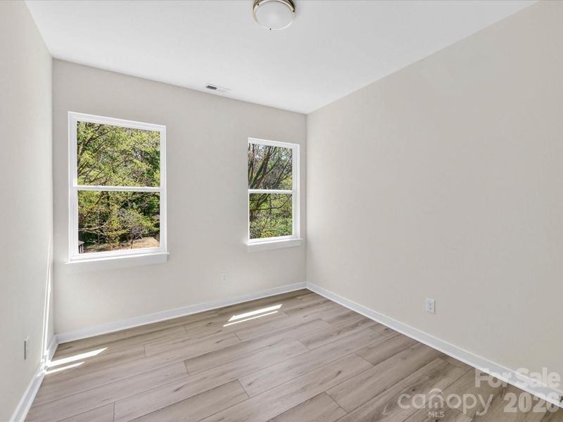 Bright secondary bedroom featuring abundant natural light, neutral finishes, and a versatile layout perfect for guests, family, or a home office. Bright secondary bedroom featuring abundant natural light, neutral finishes, and a versatile layout perfect for guests, family, or a home office.