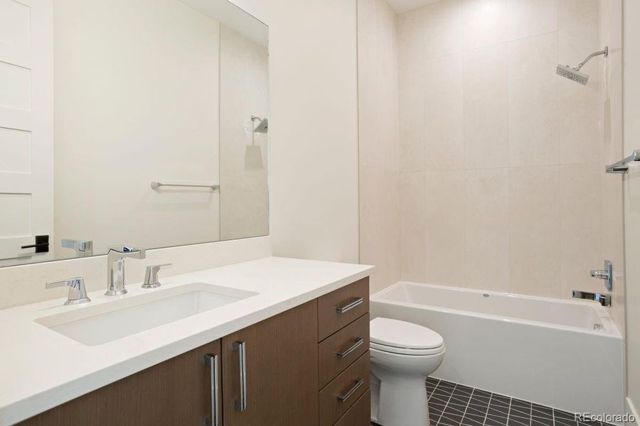 Full en suite bathroom to lower-level bedroom 3.