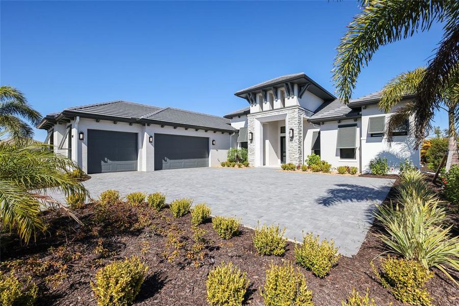 Front exterior of a new home in Wild Blue at Waterside, Sarasota, FL, highlighting curb appeal (Image 24). Front exterior of a new home in Wild Blue at Waterside, Sarasota, FL, highlighting curb appeal (Image 24).