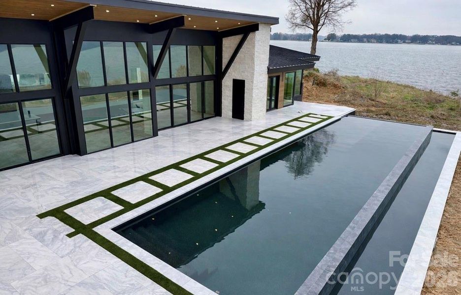 60’ Double Infinity Edge Saltwater Lap Pool w/ Cabo Shelf & Integrated Hot Tub- Accessible from Living Rooms, Kitchen, & Primary Suite