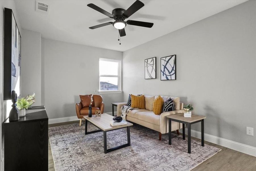 Living room with ceiling fan and wood-type flooring