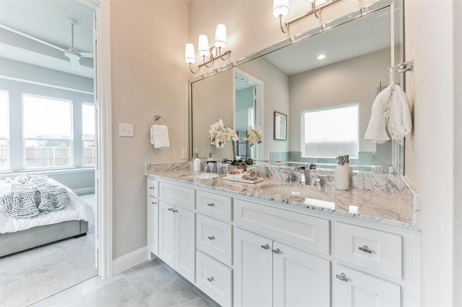 Bathroom with tile patterned floors and double sink vanity