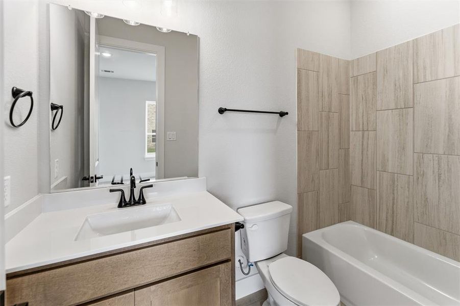 Bathroom featuring vanity and shower / bath combination