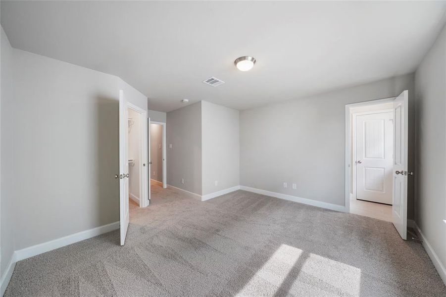 Spacious secondary bedrooms boast generous walk-in closets and direct access to the well-appointed shared bathroom. (Sample photos of a completed Bordeaux floor plan. The image may feature alternative selections and/or upgrades.)