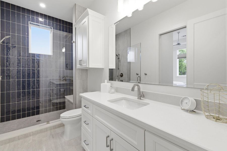 Full bath with a stall shower and vanity