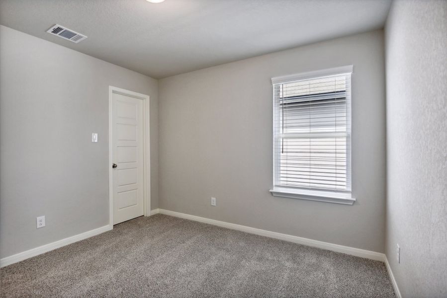 Guest bedroom in the Medina floorplan at a Meritage Homes community.