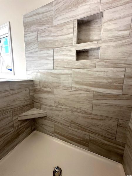 Bathroom featuring tiled shower