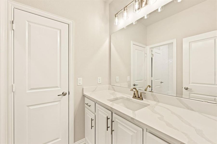 Bathroom with vanity and baseboards