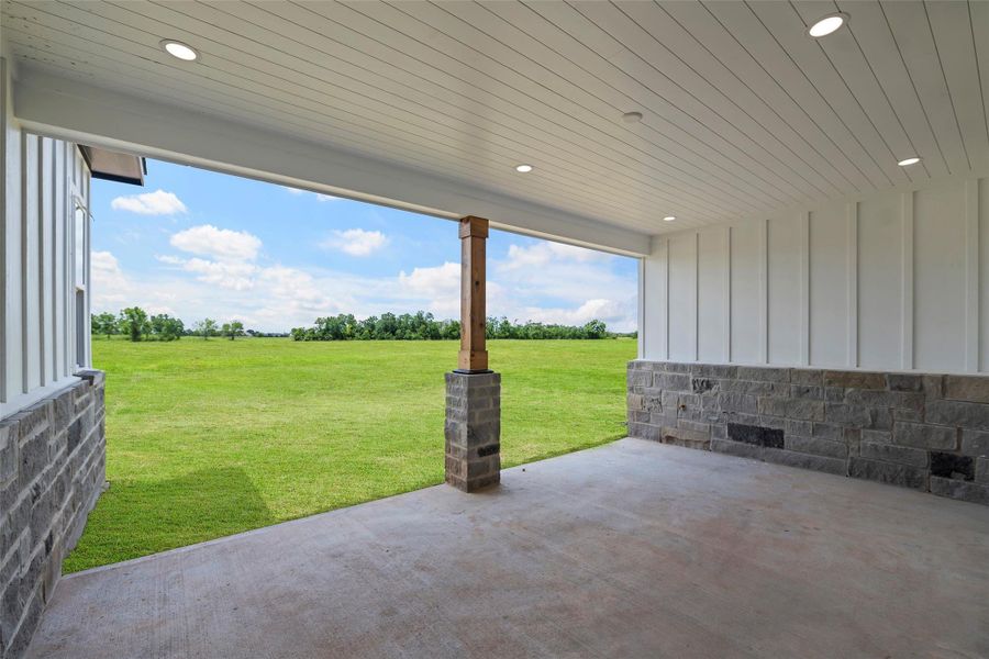 Charming covered back patio perfect for outdoor relaxation and entertaining.