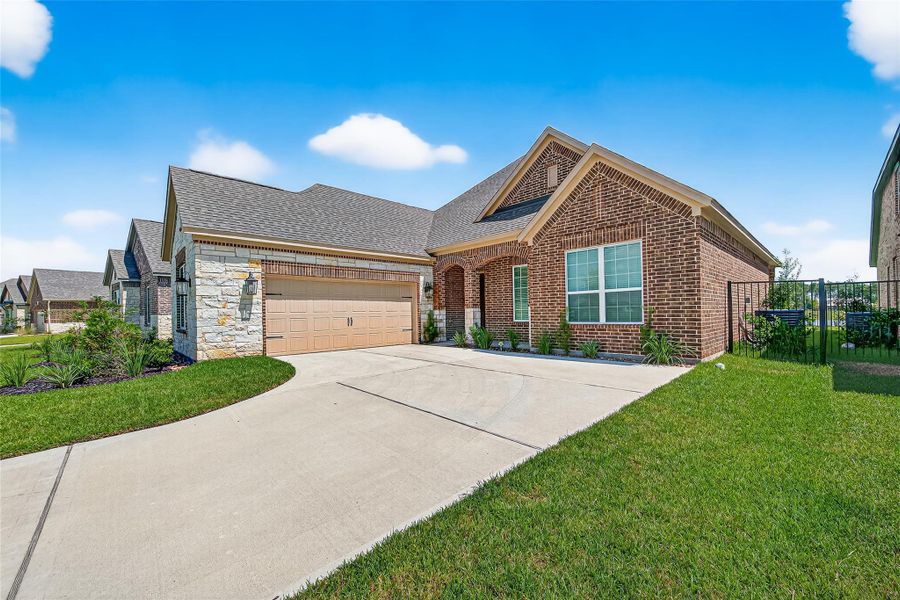 Front exterior of a new home in Sierra Vista, Iowa Colony, TX, highlighting curb appeal (Image 24). Front exterior of a new home in Sierra Vista, Iowa Colony, TX, highlighting curb appeal (Image 24).
