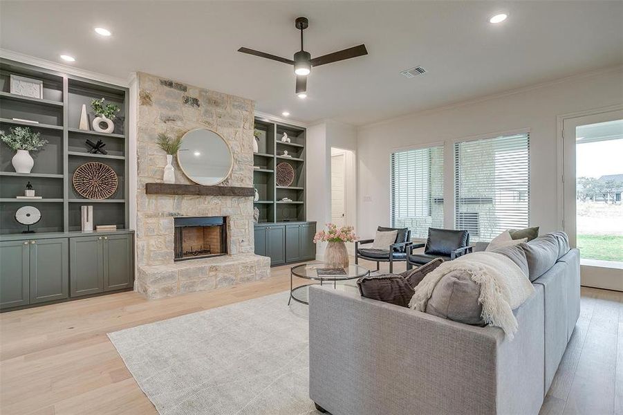 Living room with beautiful hardwood floors and 10 ft ceilings, fireplace with stone surround and cedar mantel.