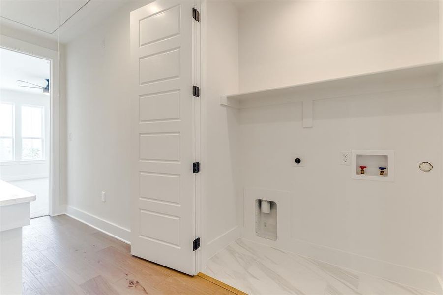 Laundry area with hookup for a washing machine, light wood-type flooring, ceiling fan, and electric dryer hookup