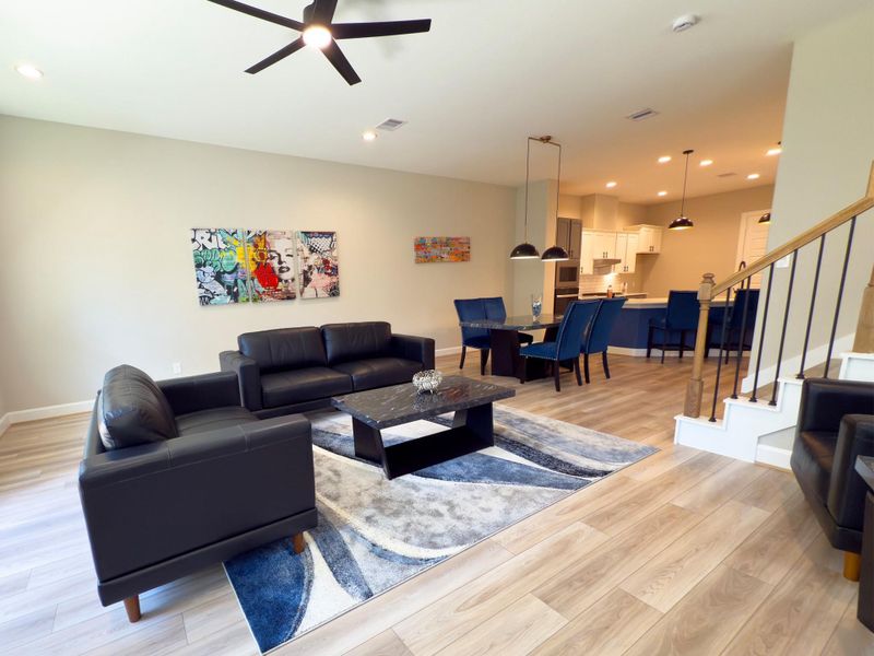 The ROCburne’s living room is designed for both comfort and style, featuring soaring ceilings, abundant natural light, and an open flow that seamlessly connects to the kitchen and dining areas—perfect for both everyday living and entertaining. Image depicts home as-is.