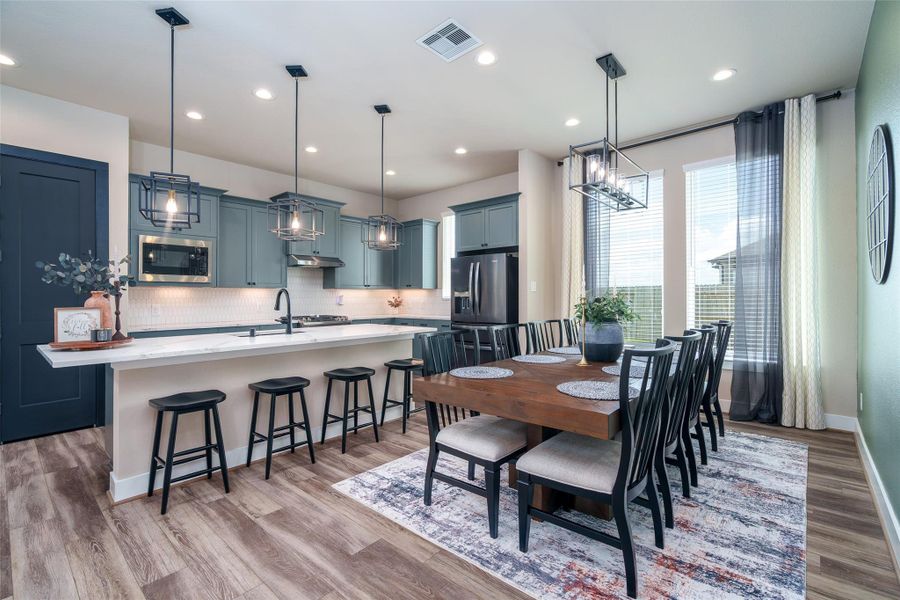 The bright and inviting dining area, located next to the kitchen, features multiple windows for natural light, stylish chandelier, and sleek recessed lighting that's perfect for enjoying your morning coffee! The bright and inviting dining area, located next to the kitchen, features multiple windows for natural light, stylish chandelier, and sleek recessed lighting that's perfect for enjoying your morning coffee!