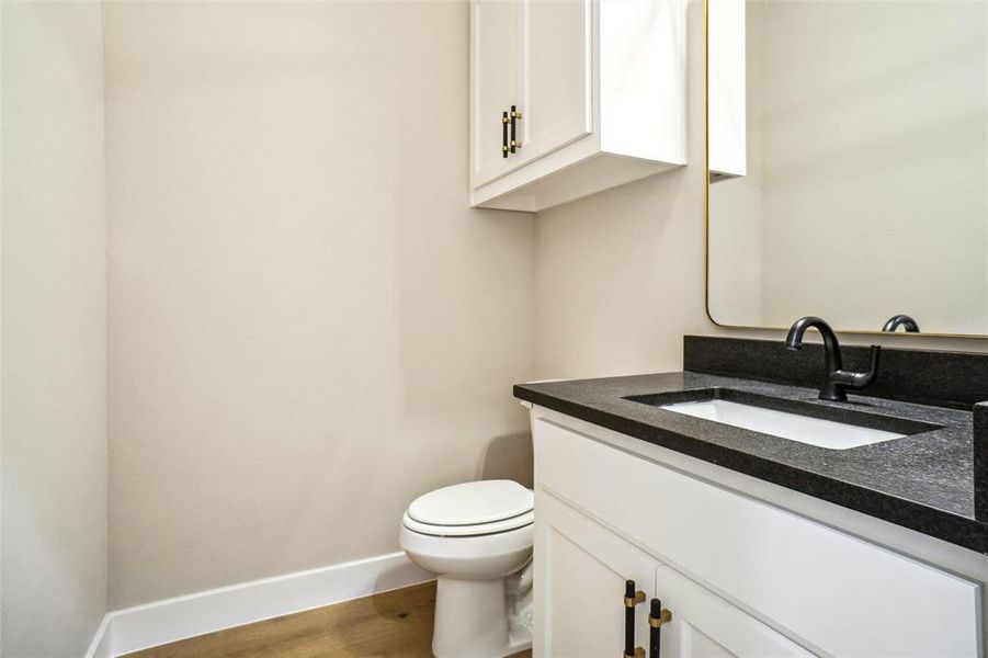 Powder bath is pretty with leathered black granite and wood flooring! Powder bath is pretty with leathered black granite and wood flooring!