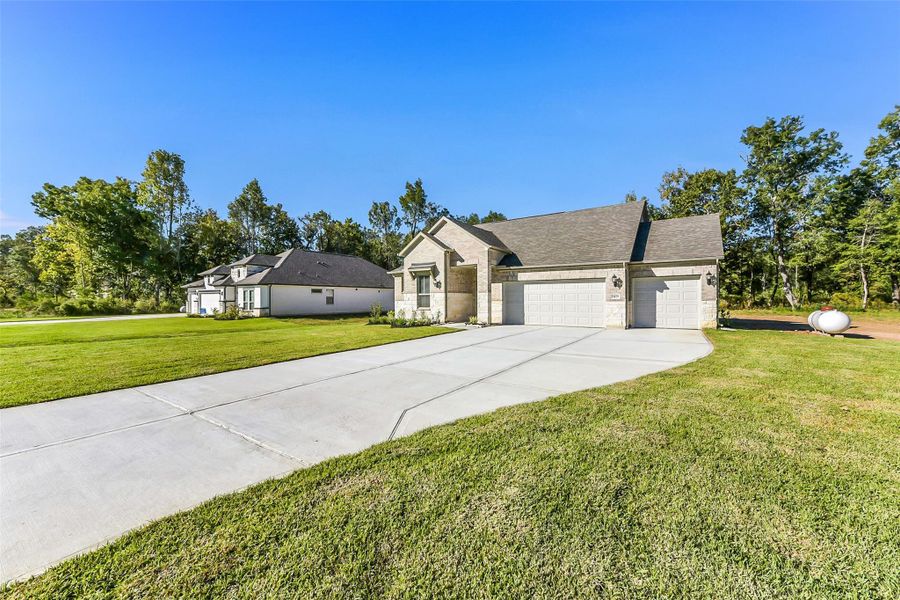 Front exterior of a new home in Encino Estates, Dayton, TX, highlighting curb appeal (Image 1). Front exterior of a new home in Encino Estates, Dayton, TX, highlighting curb appeal (Image 1).
