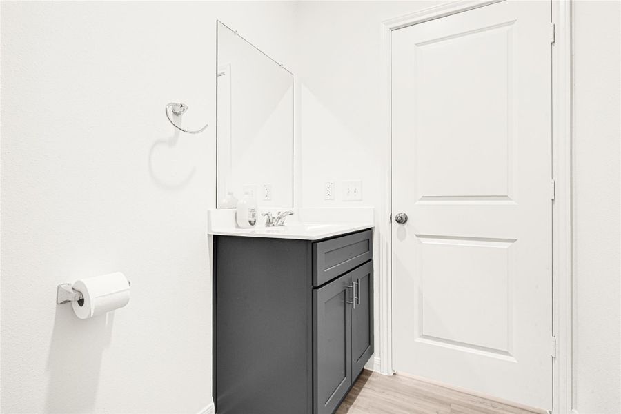 Sleek, minimalist hallway highlighting clean lines, updated doors, and a modern dark cabinet base.