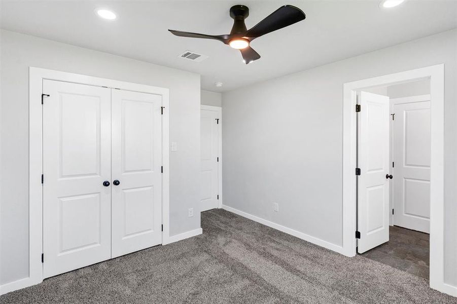 Unfurnished bedroom featuring carpet, baseboards, recessed lighting, a closet, and ceiling fan