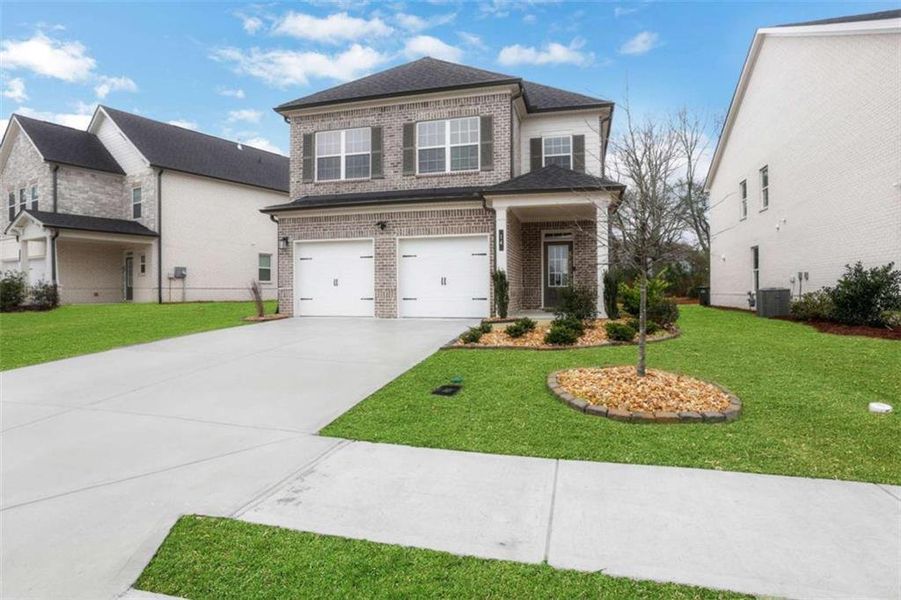 Front exterior of a new home in Graystone Village, Grayson, GA, highlighting curb appeal (Image 1). Front exterior of a new home in Graystone Village, Grayson, GA, highlighting curb appeal (Image 1).