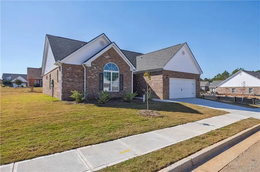 Front exterior of a new home in , Social Circle, GA, highlighting curb appeal (Image 22). Front exterior of a new home in , Social Circle, GA, highlighting curb appeal (Image 22).