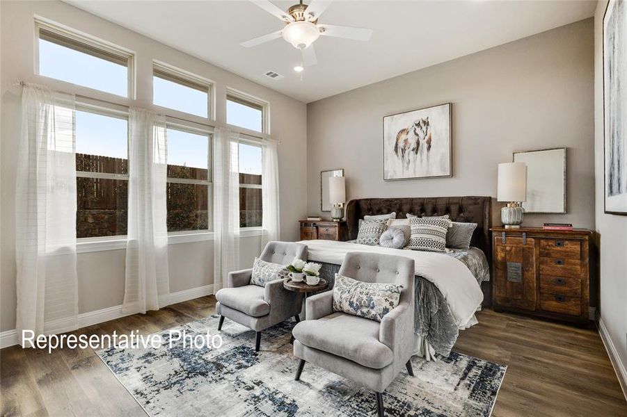 Bedroom with ceiling fan and dark wood-type flooring