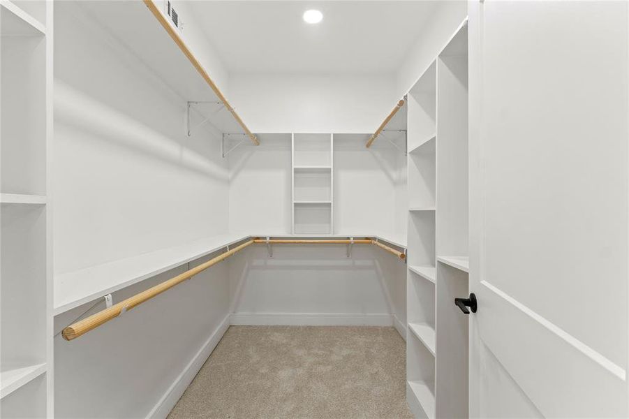 Walk in closet featuring carpet Walk in closet featuring carpet