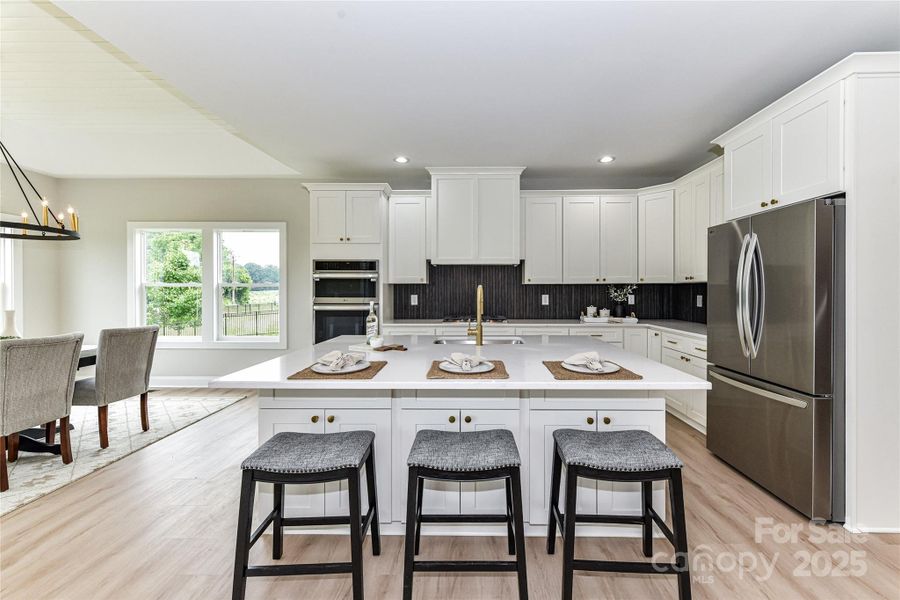 Upgrades throughout Kitchen including quartz counters, stainless steel appliances, gas cook top with vented hood, wall oven, spacious island with seating/storage, custom, tile back splash, plenty of cabinets for storage, dining area & pantry! Upgrades throughout Kitchen including quartz counters, stainless steel appliances, gas cook top with vented hood, wall oven, spacious island with seating/storage, custom, tile back splash, plenty of cabinets for storage, dining area & pantry!