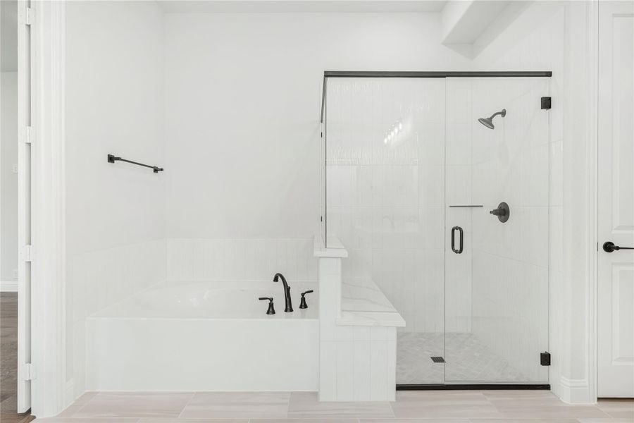 Bathroom with soaking tub and glass-enclosed walk-in shower, white tile walls and matte black fixtures Bathroom with soaking tub and glass-enclosed walk-in shower, white tile walls and matte black fixtures