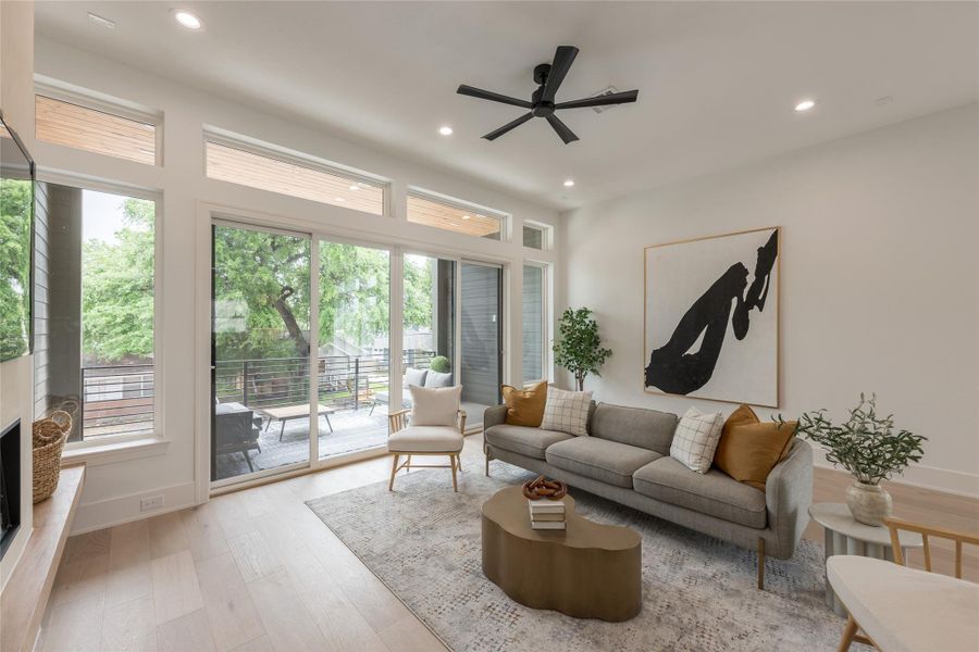 A living room that understands Houston afternoons. The balcony is shaded, covered, and detailed with a wood-slat ceiling so the glare never overtakes the room...light arrives filtered and softened before it reaches the interior.