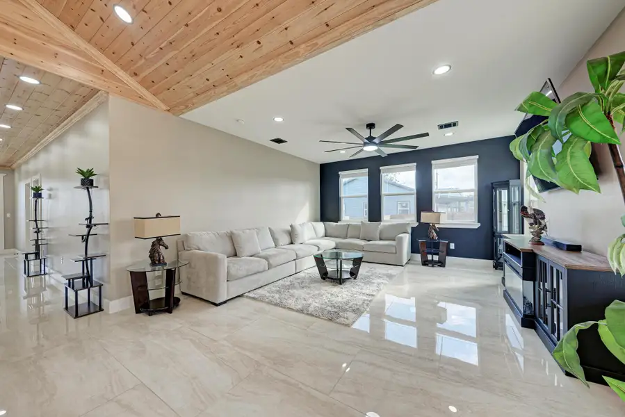 Polished tile flooring and a distinctive wood-paneled ceiling accent define this comfortable living area. Polished tile flooring and a distinctive wood-paneled ceiling accent define this comfortable living area.