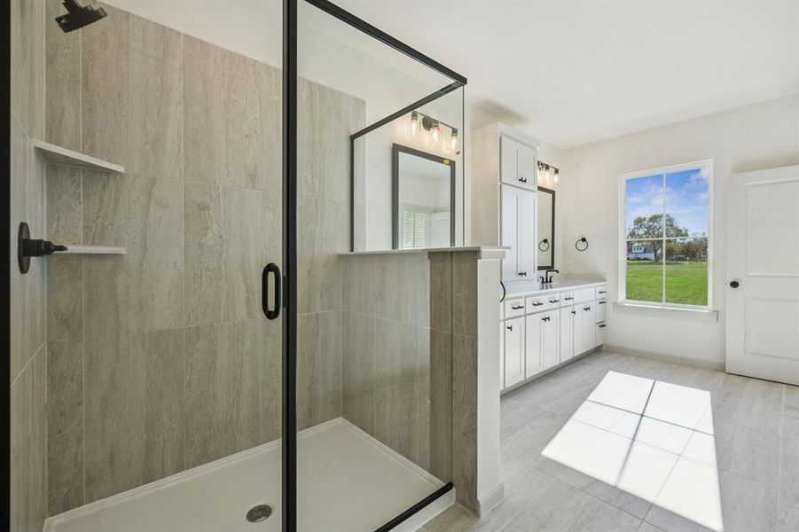 A spacious, walk in shower is the cherry on top in this beautiful Owner's bath.
