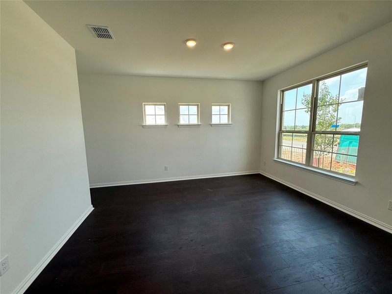 Unfurnished room featuring dark wood-style floors and recessed lighting Unfurnished room featuring dark wood-style floors and recessed lighting