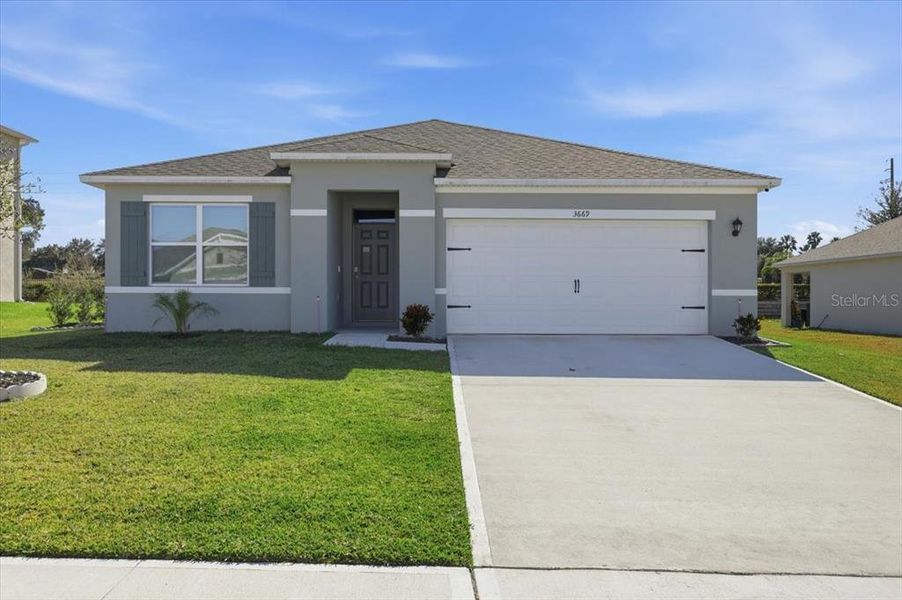Front exterior of a new home in Oak Pointe, Apopka, FL, highlighting curb appeal (Image 1). Front exterior of a new home in Oak Pointe, Apopka, FL, highlighting curb appeal (Image 1).