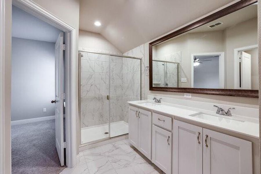Full bathroom with a marble finish shower, double vanity, a ceiling fan, marble finish flooring, and baseboards