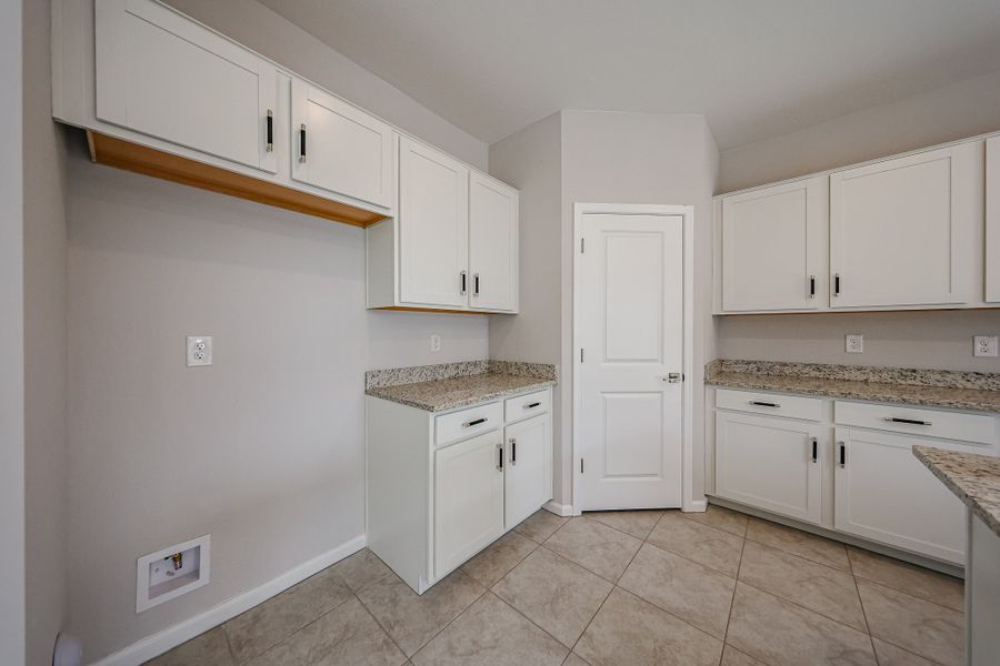 A kitchen with white cabinets.