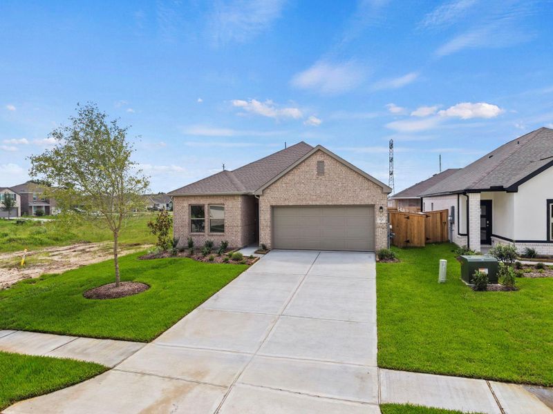 Front exterior of a new home in Windrose Green, Angleton, TX, highlighting curb appeal (Image 20). Front exterior of a new home in Windrose Green, Angleton, TX, highlighting curb appeal (Image 20).