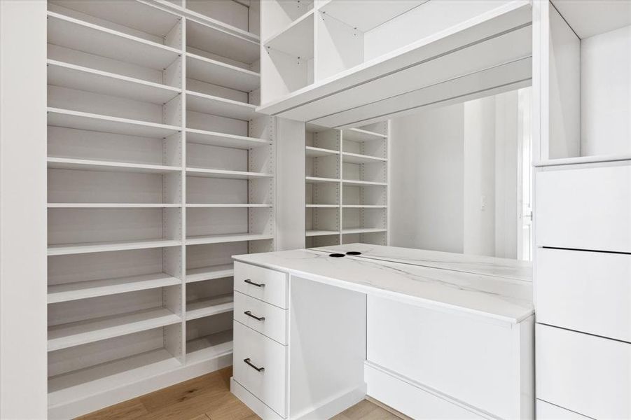 The upgraded primary closet includes a custom vanity, a wonderful addition!