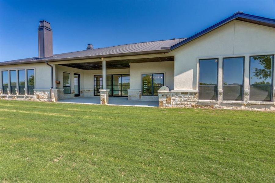 Back of house featuring a yard and a patio area