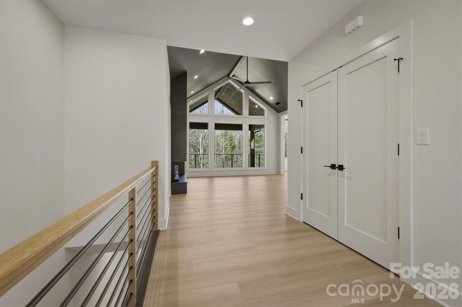 From the front door, straight ahead you will walk past the horizontal contemporary railing and the large coat closet into the main living areas. There are beautiful sight lines through the living room out to the covered porch and the serenity of the outdoor areas. From the front door, straight ahead you will walk past the horizontal contemporary railing and the large coat closet into the main living areas. There are beautiful sight lines through the living room out to the covered porch and the serenity of the outdoor areas.