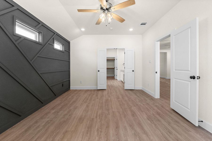 Unfurnished bedroom with light wood-style floors, ceiling fan, recessed lighting, and vaulted ceiling