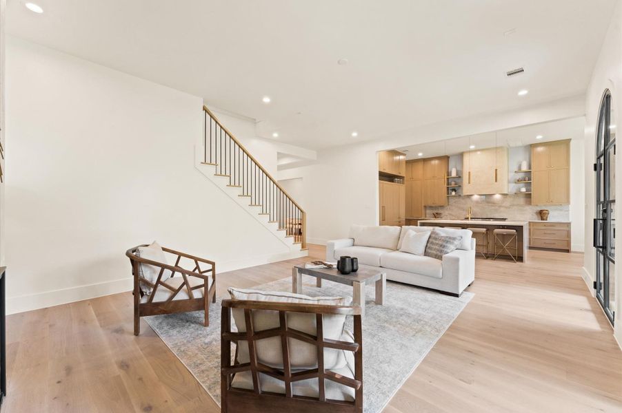 Living area with view of kitchen. *Previous project by the same developer, floor plans and selections may vary.*