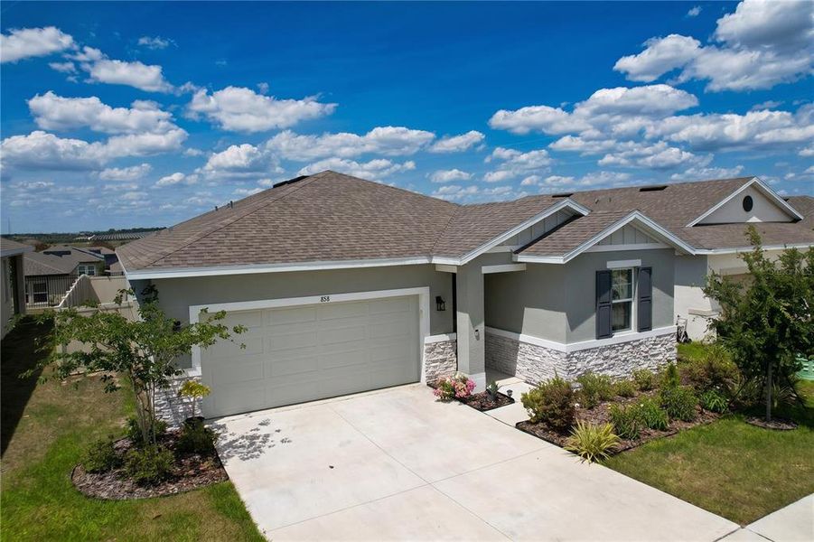 Front exterior of a new home in Seasons at Mabel Place, Lake Wales, FL, highlighting curb appeal (Image 32).